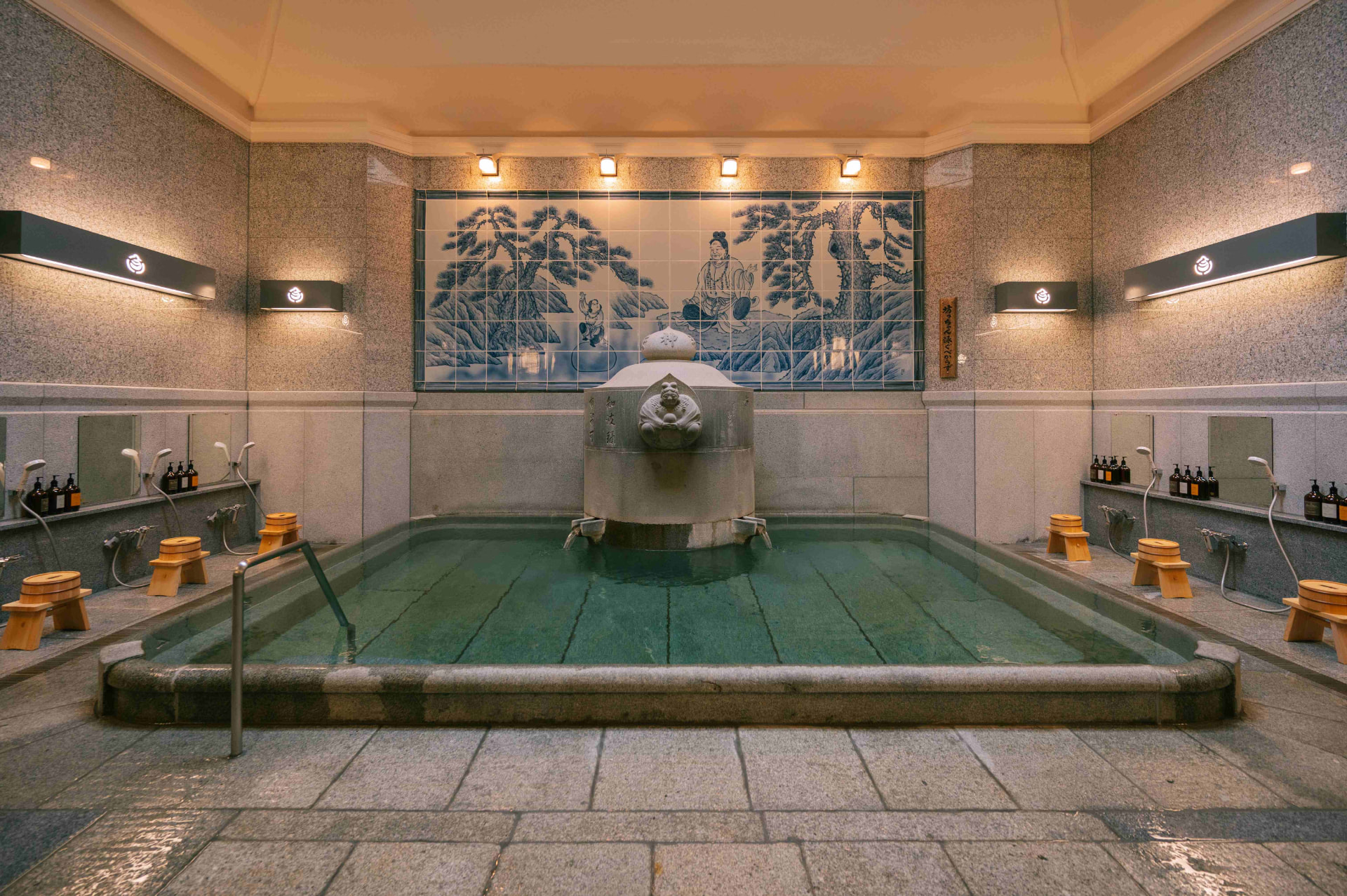 Kami-no-Yu bathing room at Dogo Onsen Honkan with its tiled mural and stone bath